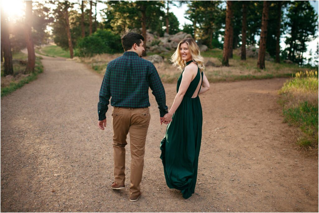 Couple walks holding hands along mountain trail