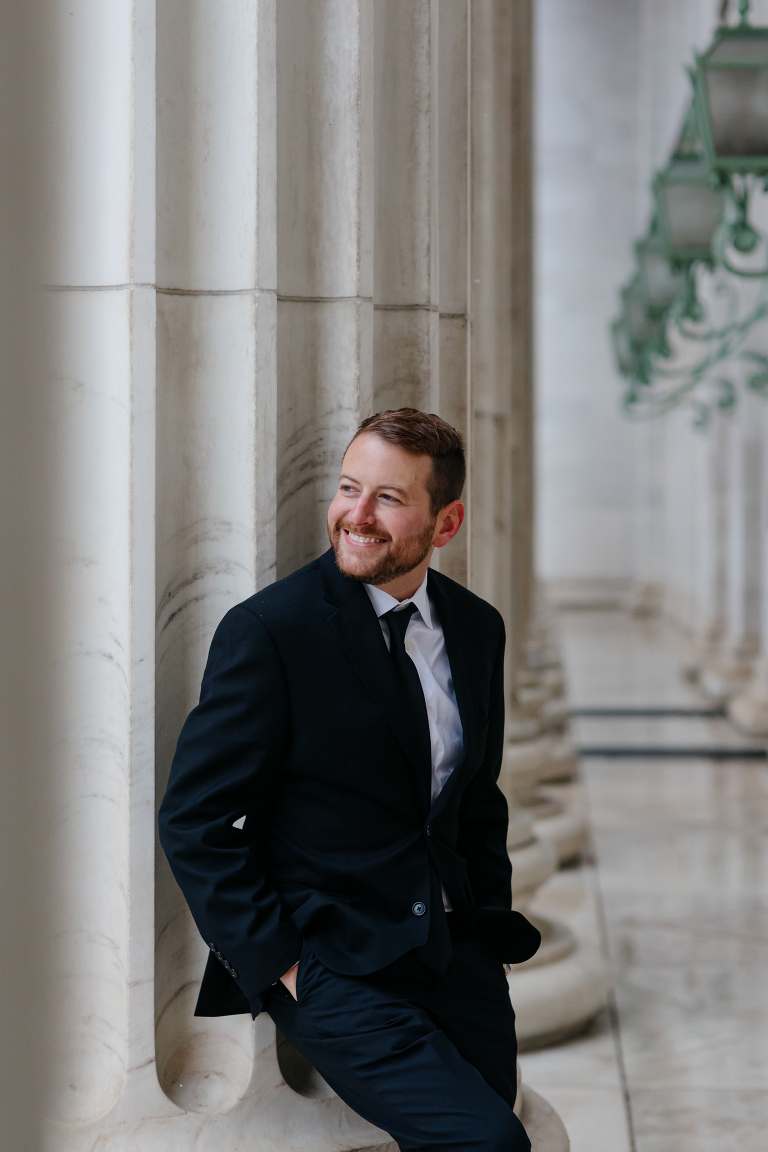 Groom posing for photos in Denver courthouse elopement