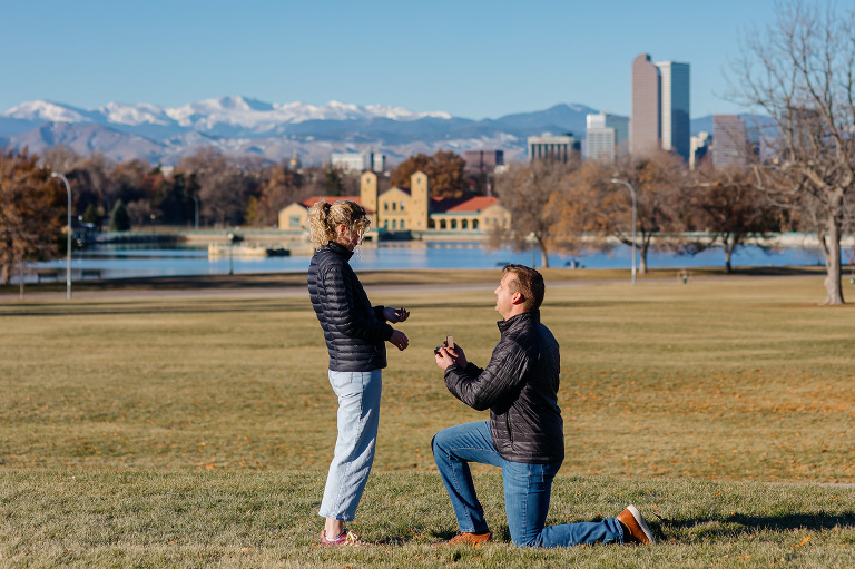 Proposal photos at City Park in Denver with city and mountains in the background