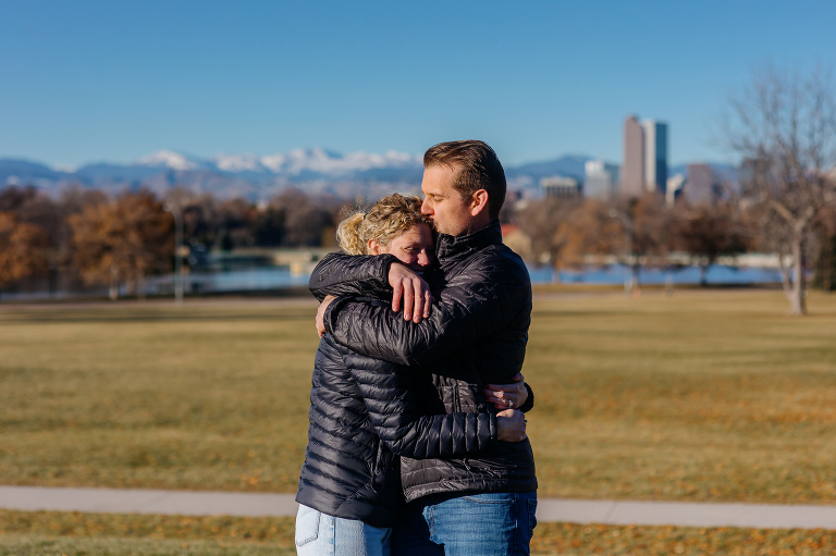 Proposal photos at City Park in Denver with city and mountains in the background