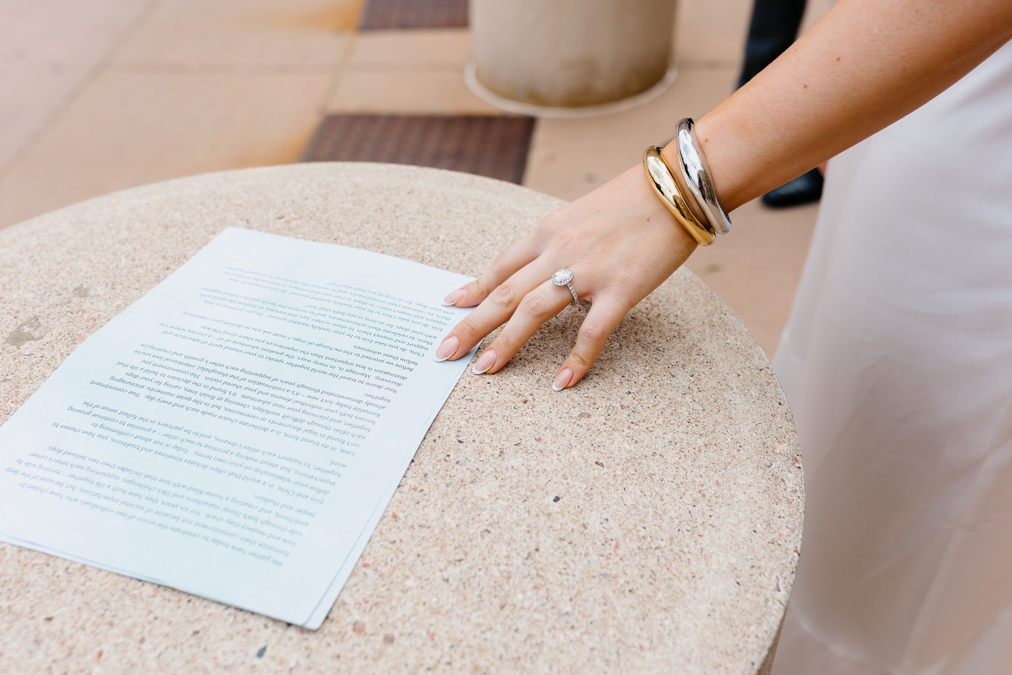 Photo of Colorado bride touching wedding vows typed up on paper