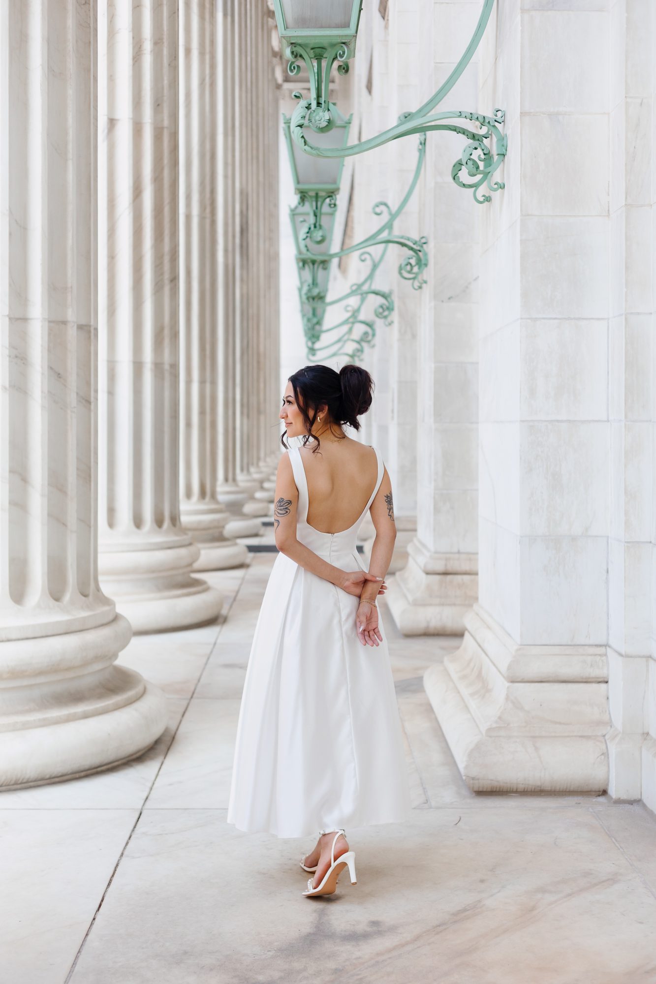 Bride in vintage-inspired teacup-length wedding dress walking outside Denver courthouse