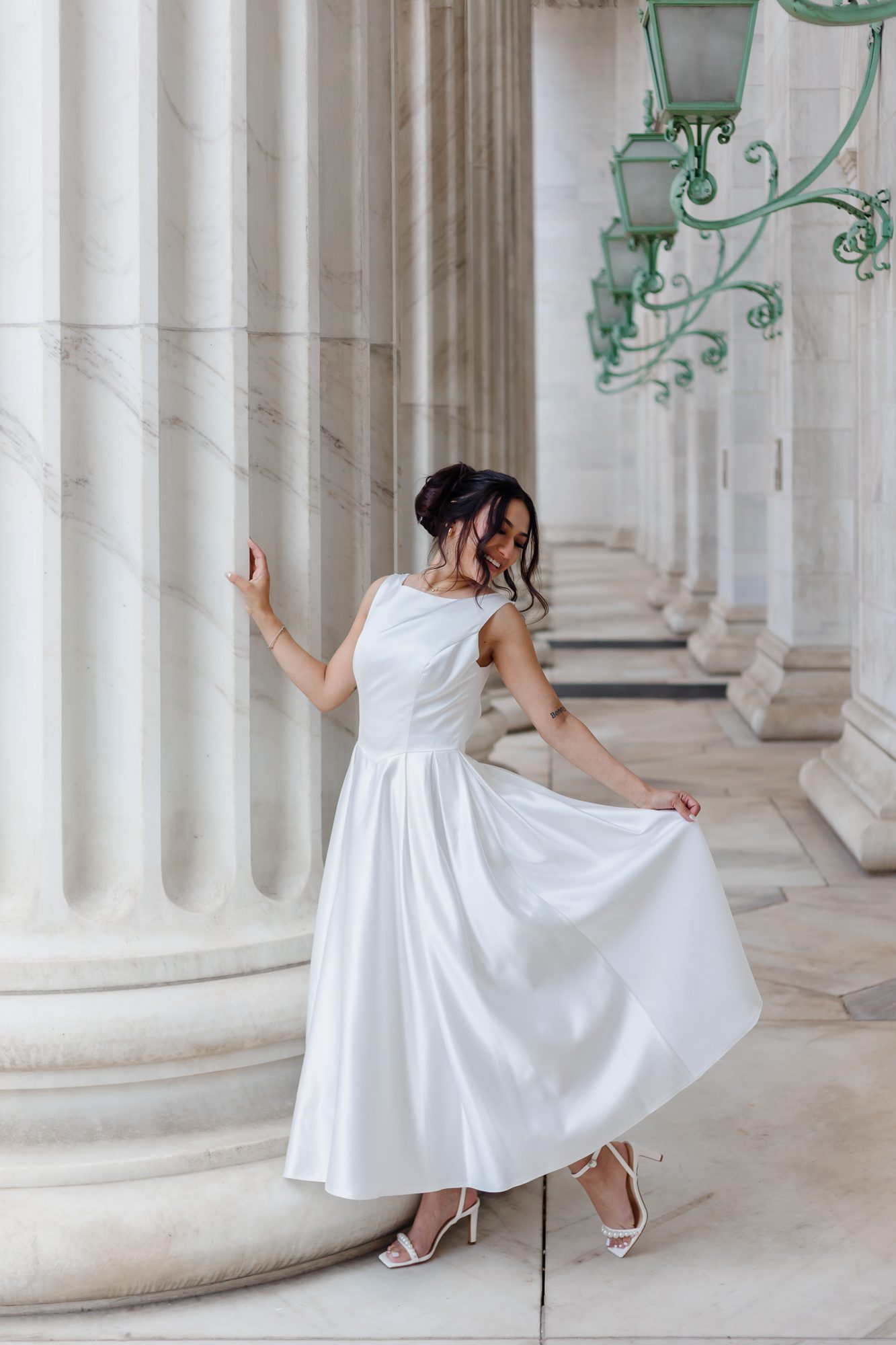 Bride in vintage-inspired teacup-length wedding dress walking outside Denver courthouse