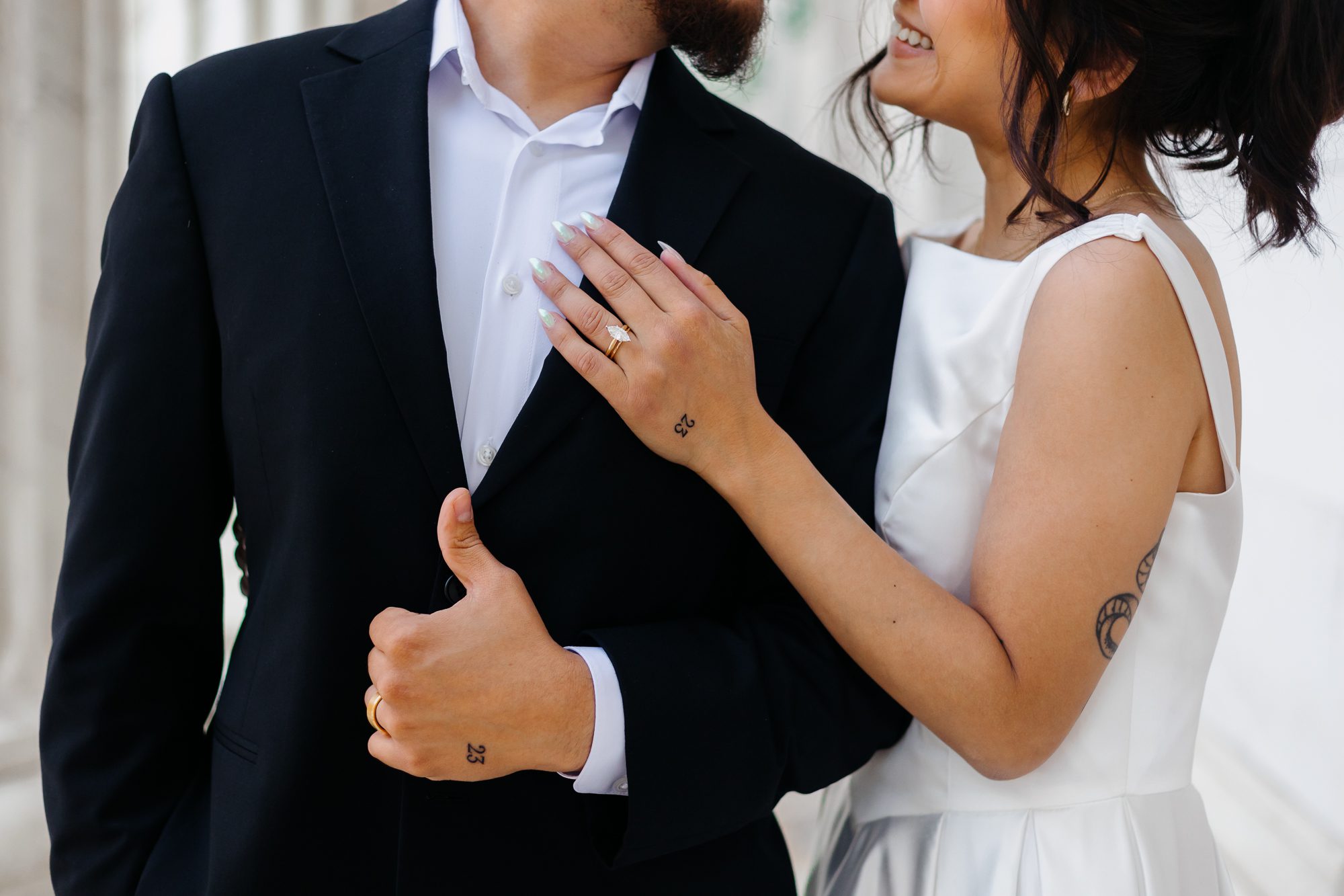 Close-up of matching hand tattoos commemorating their elopement