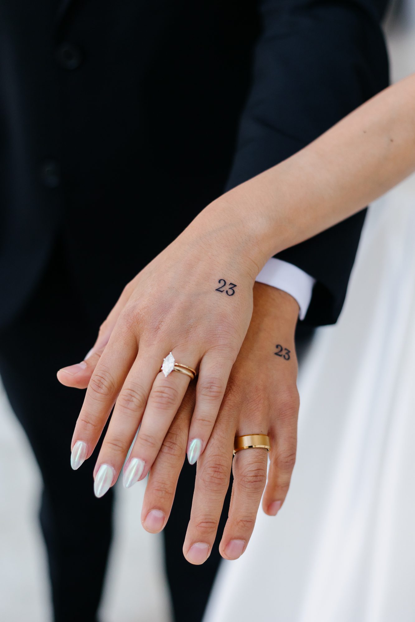 Close-up of matching hand tattoos commemorating their elopement