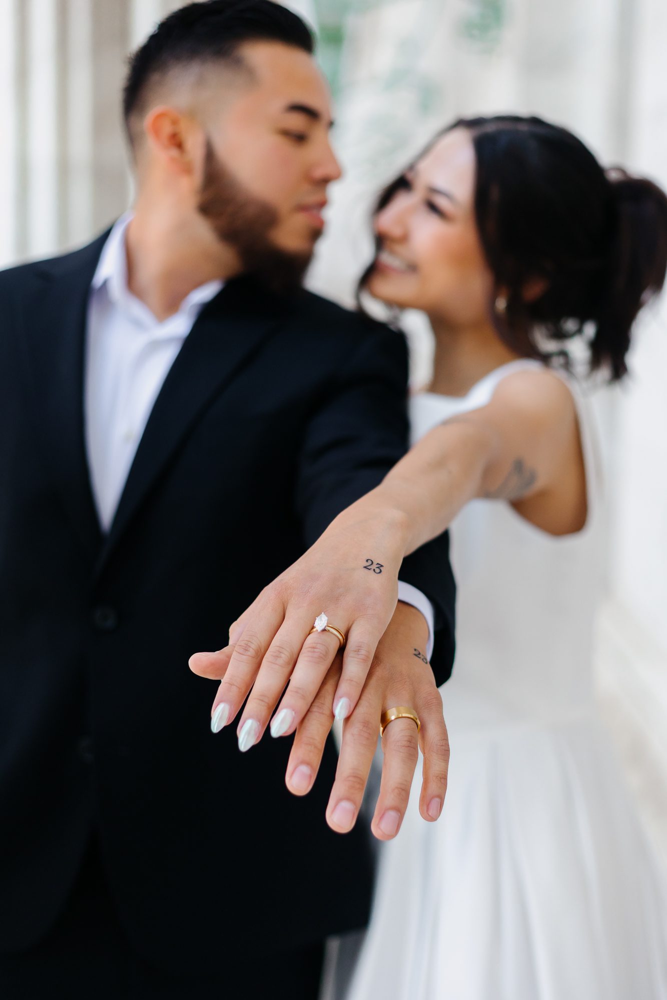 Close-up of matching hand tattoos commemorating their elopement