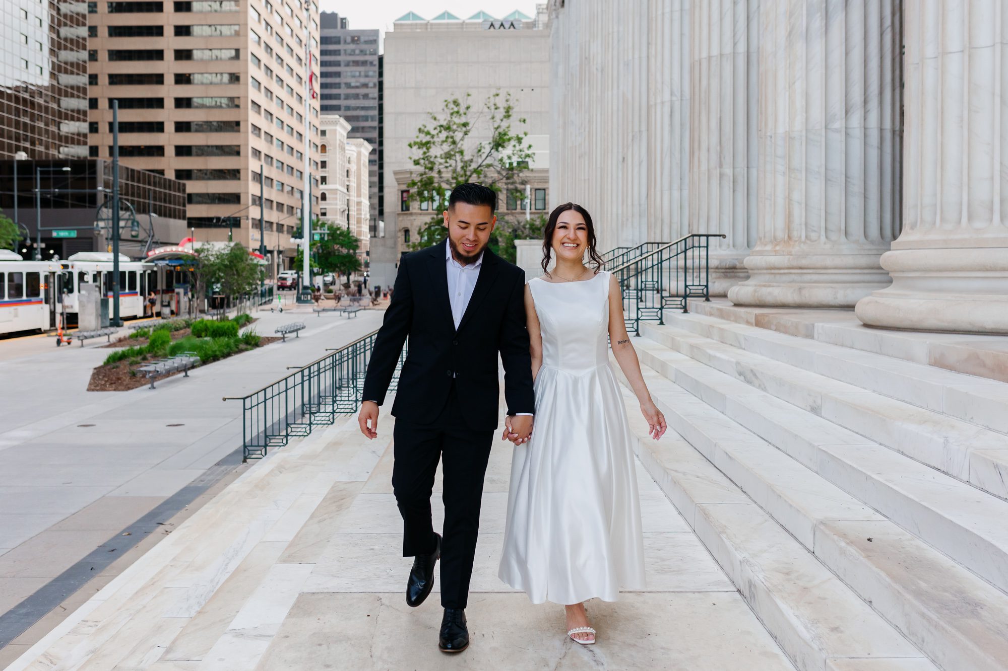 Couple walking hand in hand after Denver courthouse elopement