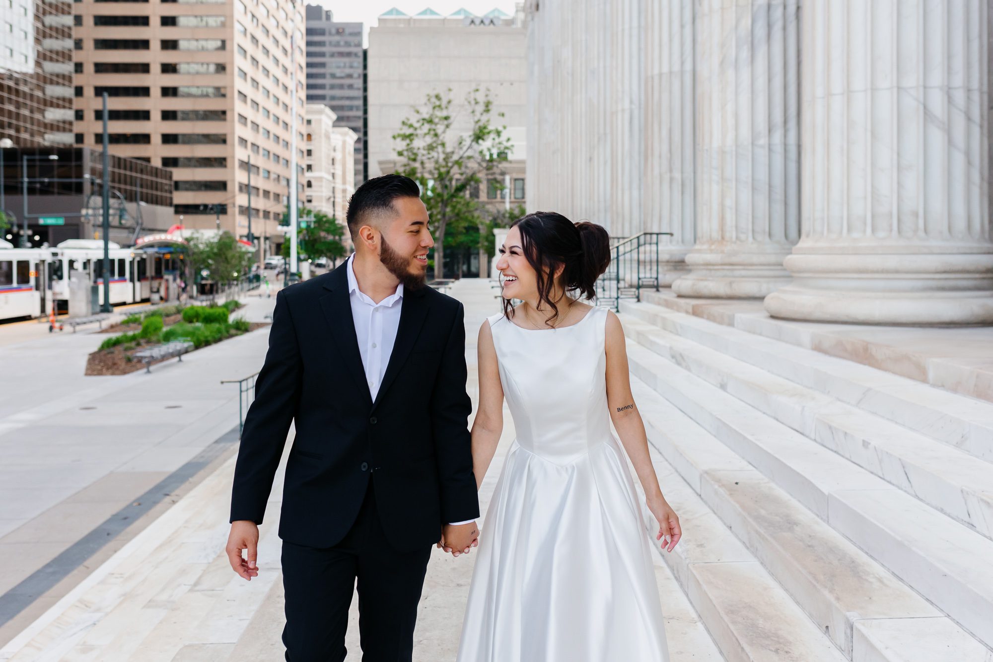 Couple walking hand in hand after Denver courthouse elopement