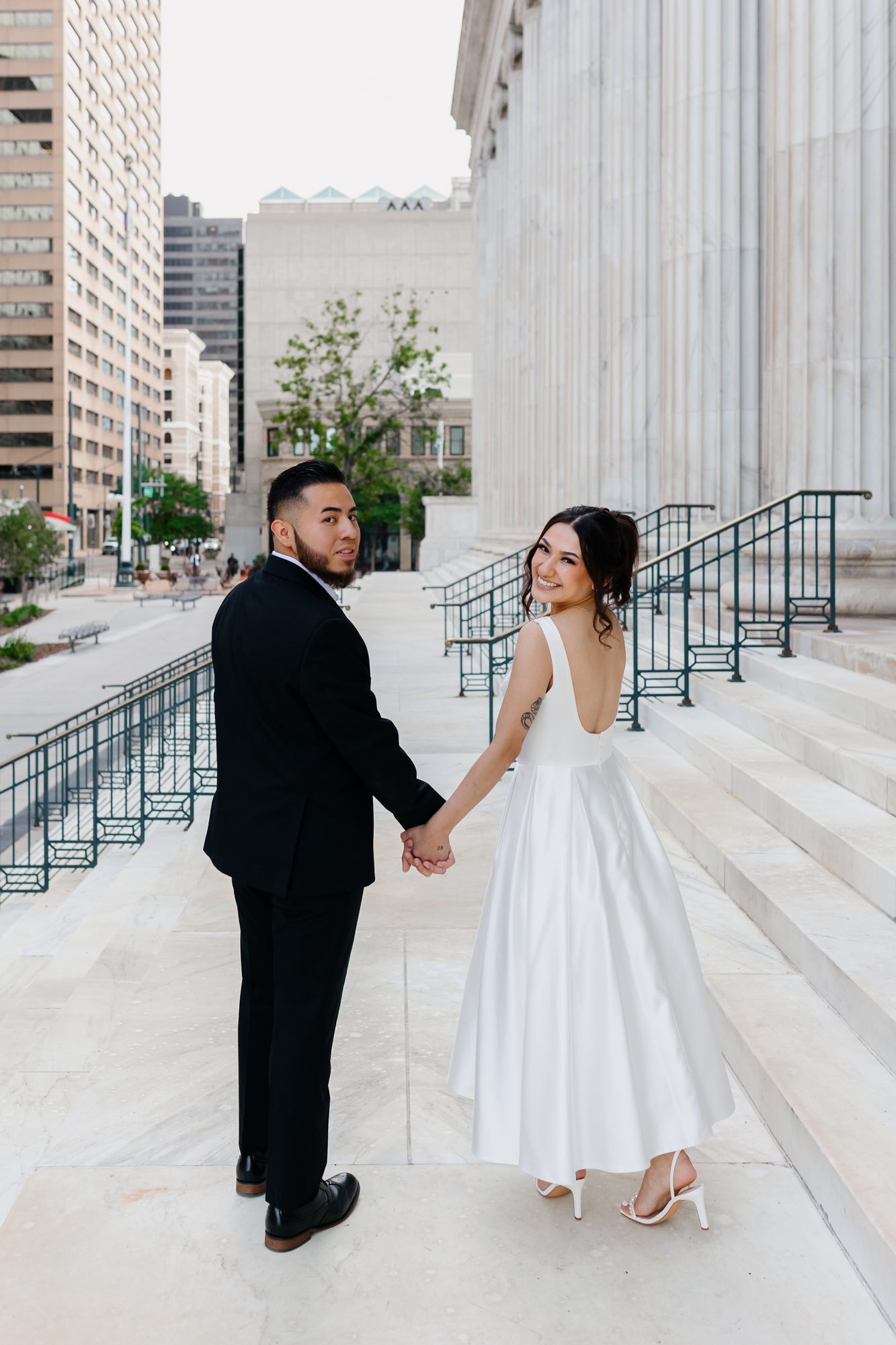 Couple walking hand in hand after Denver courthouse elopement