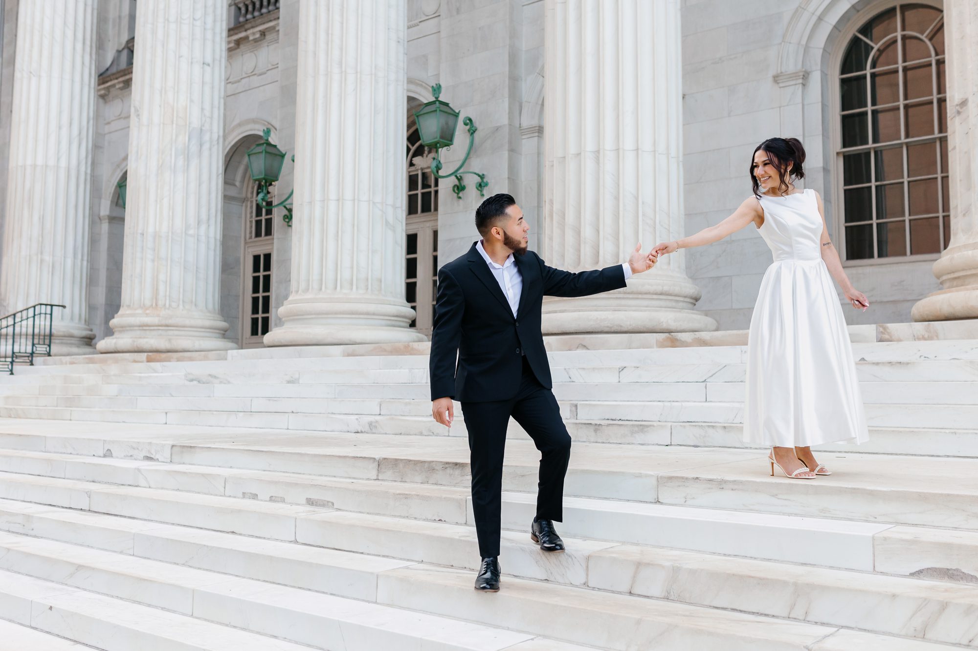 Couple walking hand in hand after Denver courthouse elopement