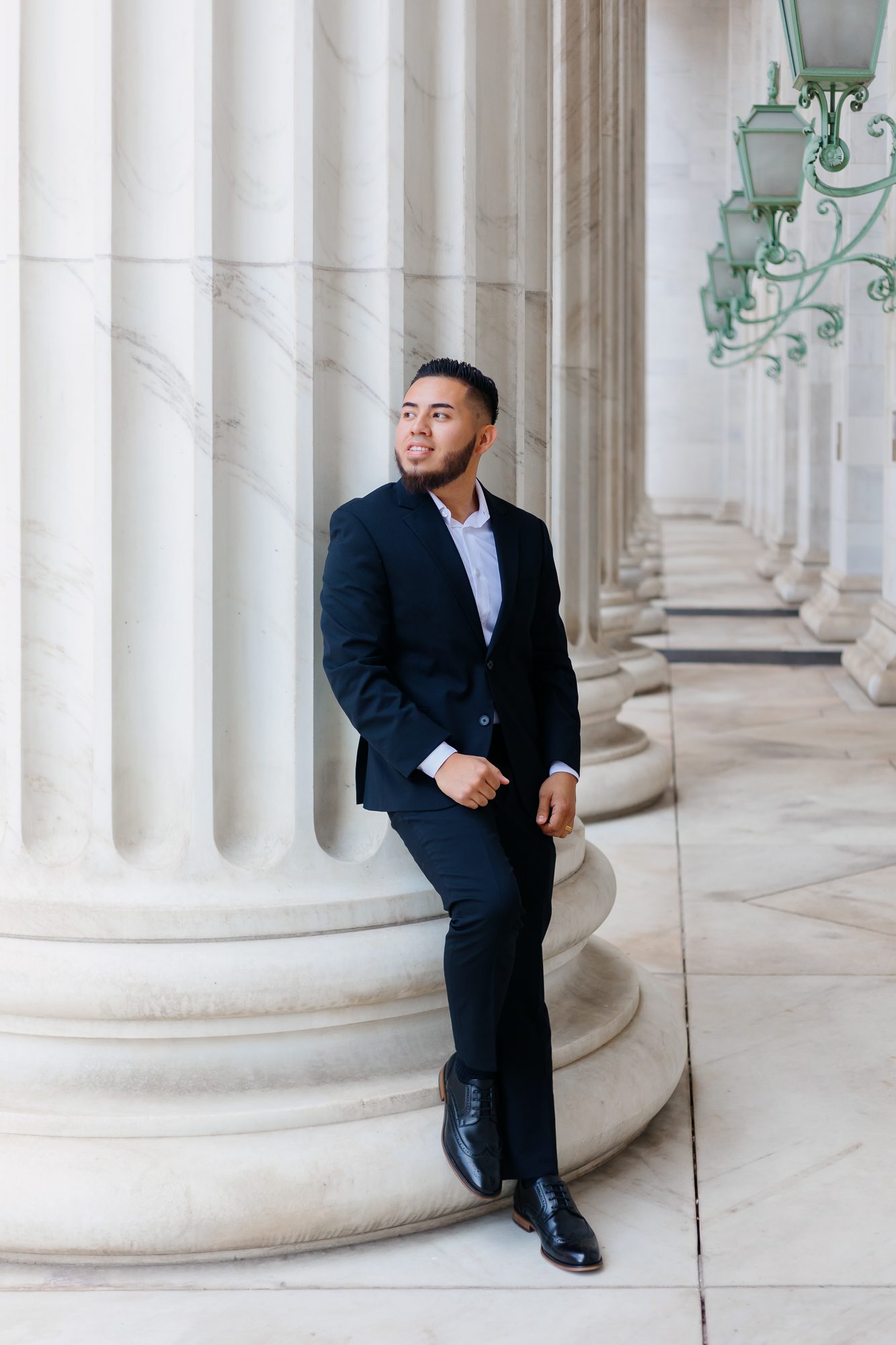 Groom standing at courthouse after eloping with bride in Denver