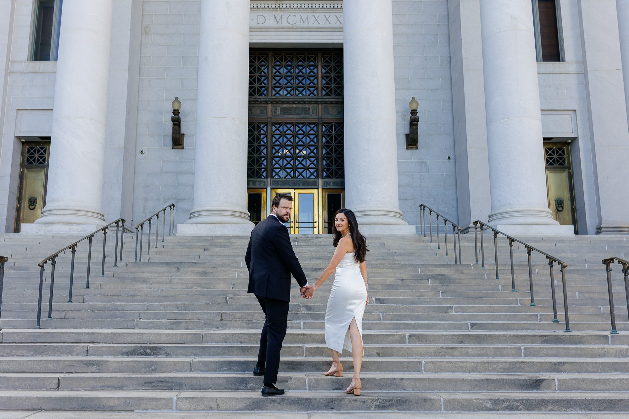 Denver courthouse elopement photographer captures bride and groom walking up to courthouse ceremony