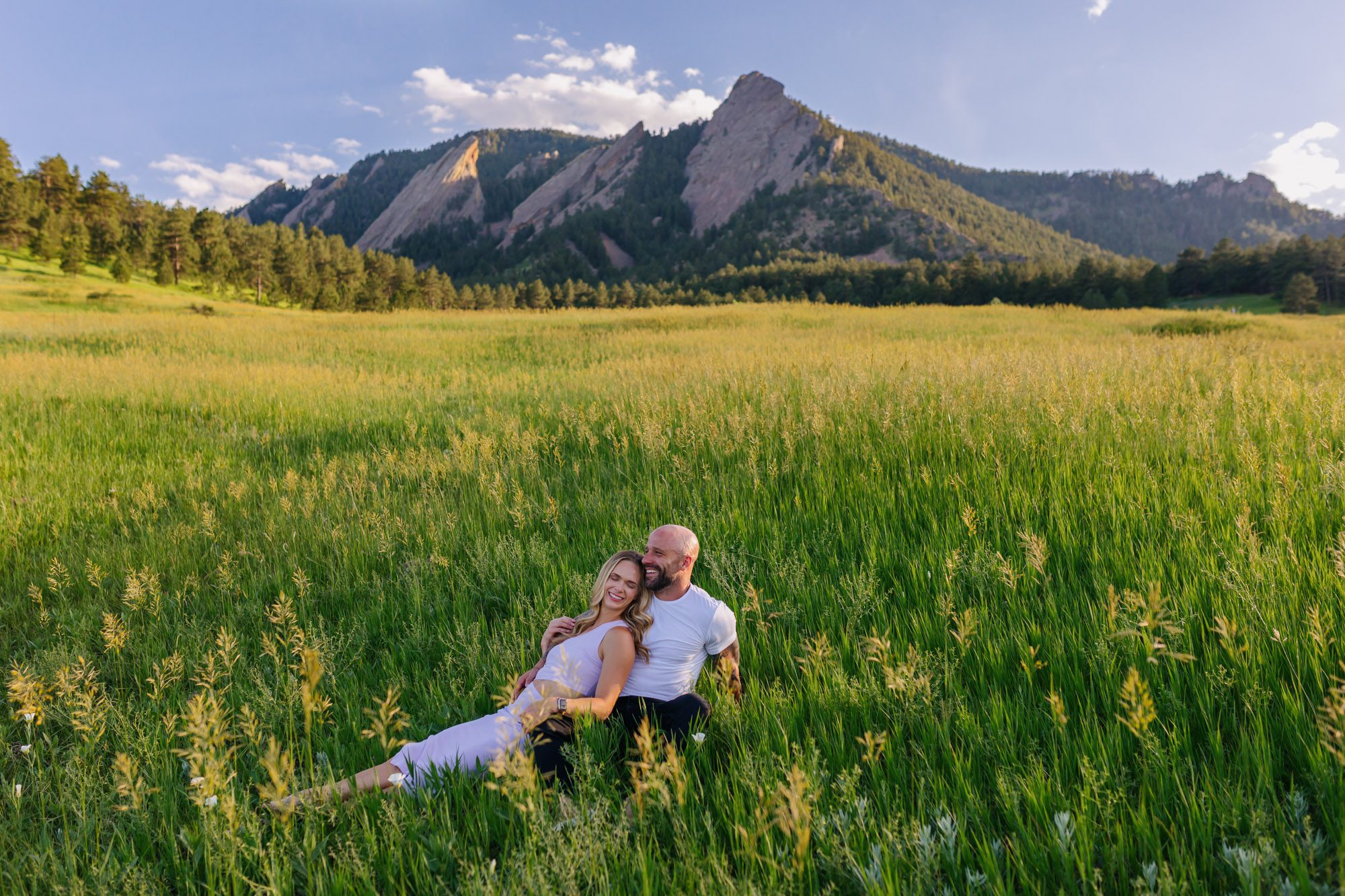 Couple posing for photos at Chautauqua Park in Boulder