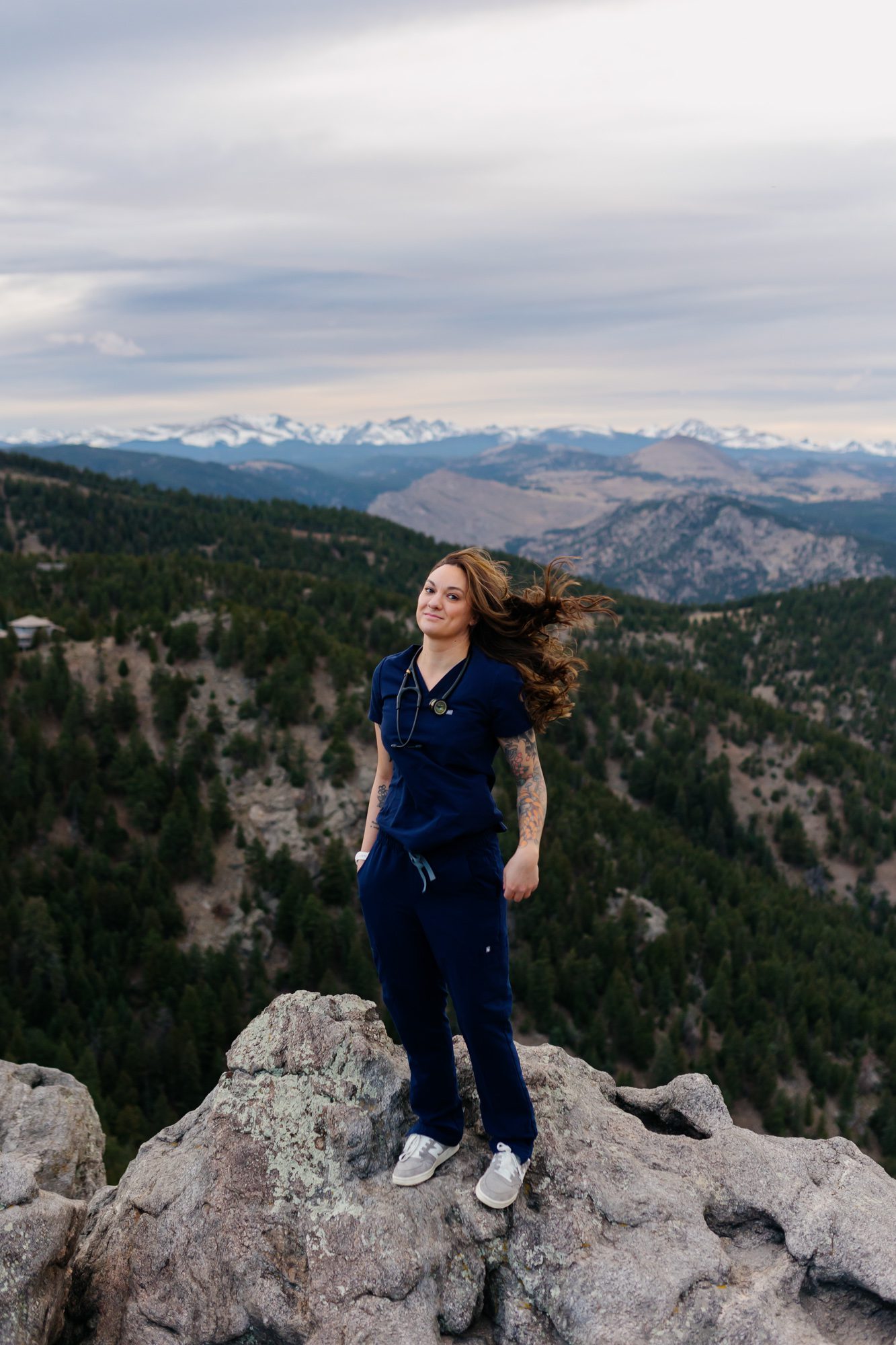 Recent Front Range Community College grad posing for Boulder graduation session at Lost Gulch