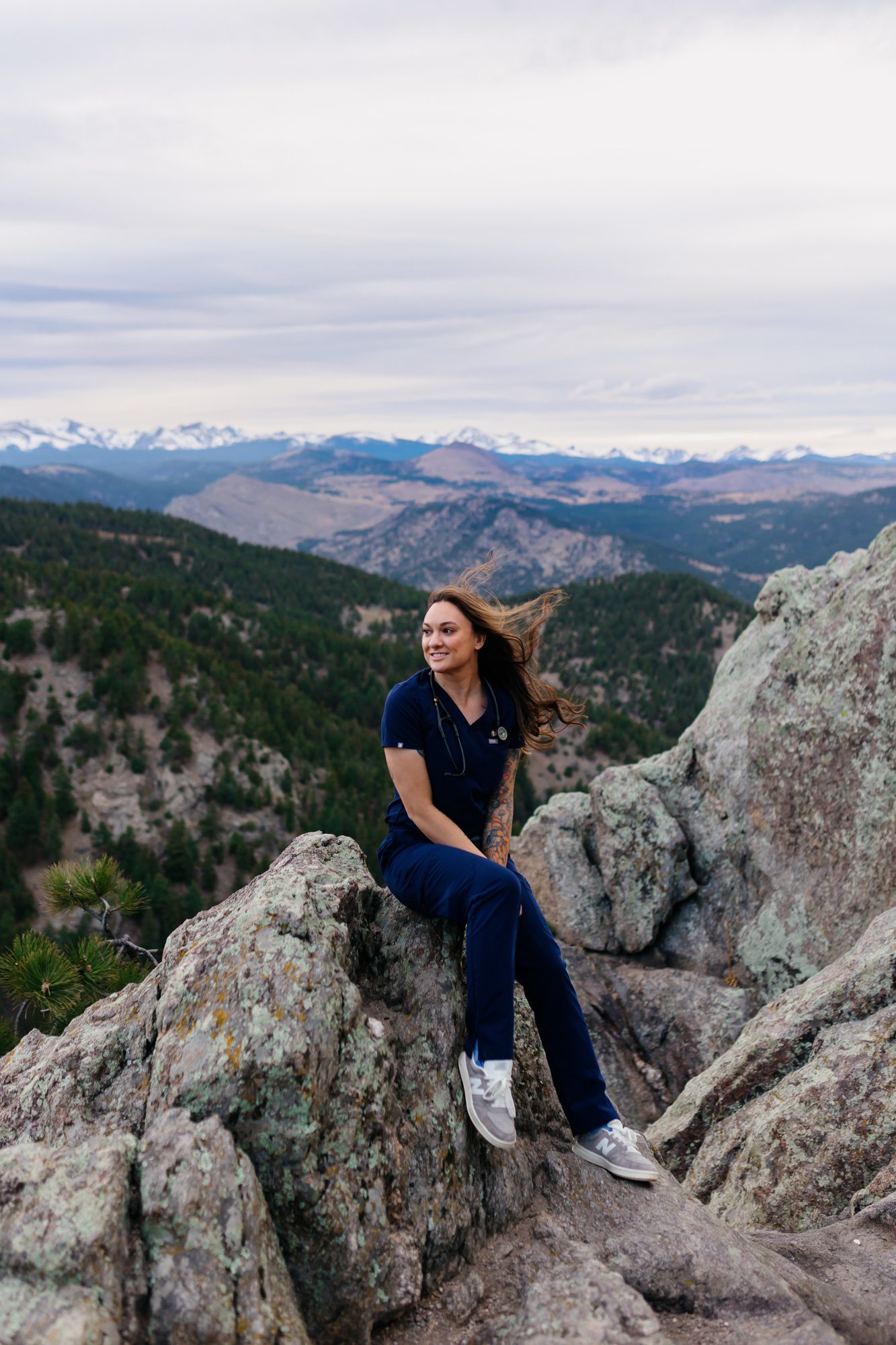 Recent Front Range Community College grad posing for Boulder graduation session at Lost Gulch